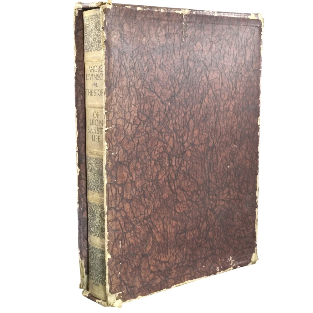 The spine of an antique hardcover book featuring intricate gilt floral patterns and lettered text reading The Story of Leon Baksts Life by Andre Levinson. View II