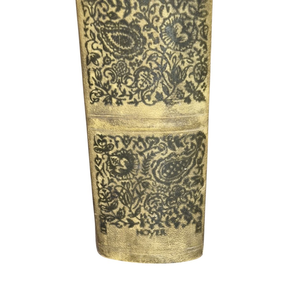 The spine of an antique hardcover book featuring intricate gilt floral patterns and lettered text reading The Story of Leon Baksts Life by Andre Levinson. View VI
