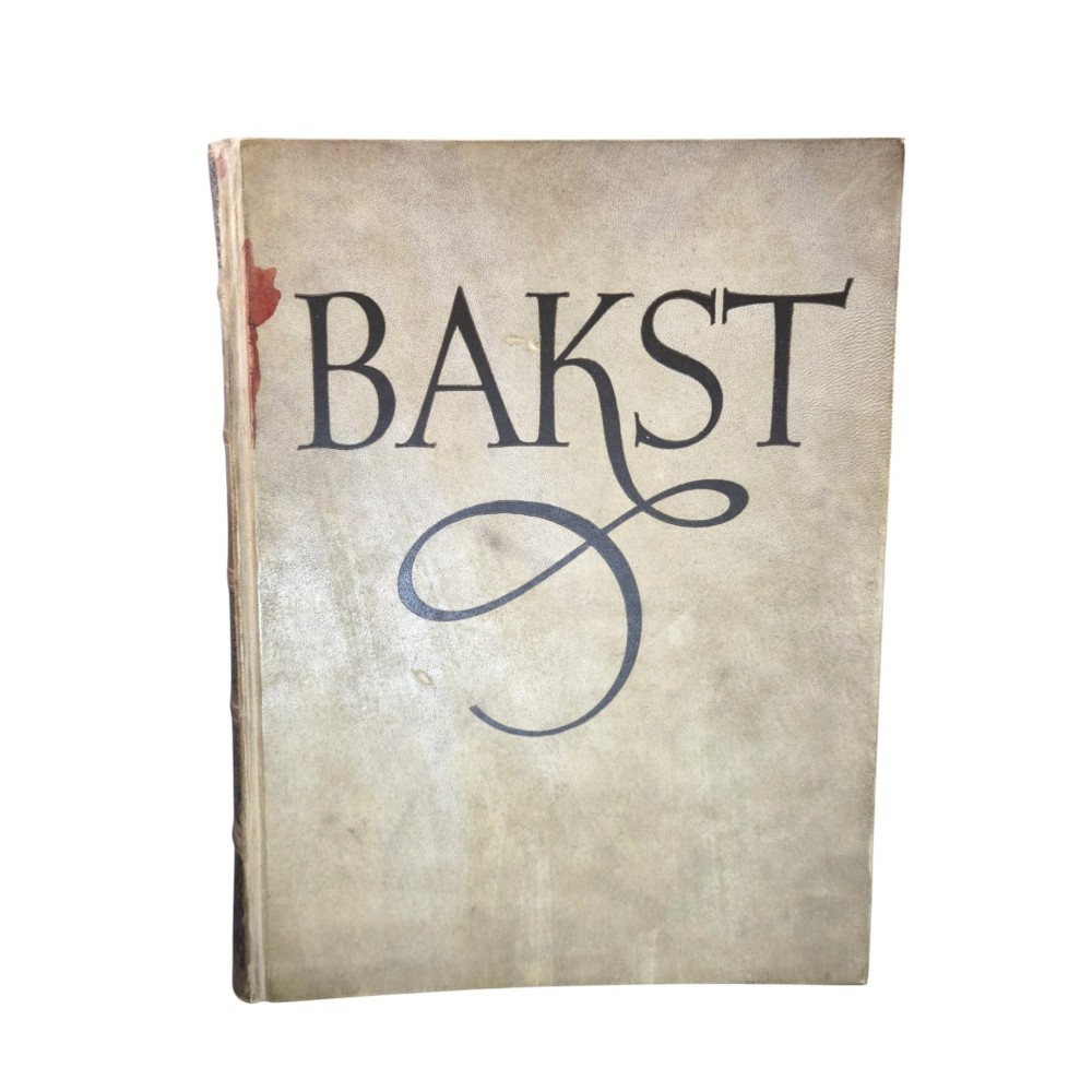 The spine of an antique hardcover book featuring intricate gilt floral patterns and lettered text reading The Story of Leon Baksts Life by Andre Levinson. View VII