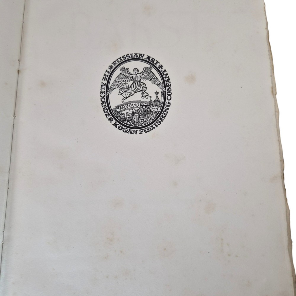 The spine of an antique hardcover book featuring intricate gilt floral patterns and lettered text reading The Story of Leon Baksts Life by Andre Levinson. View X