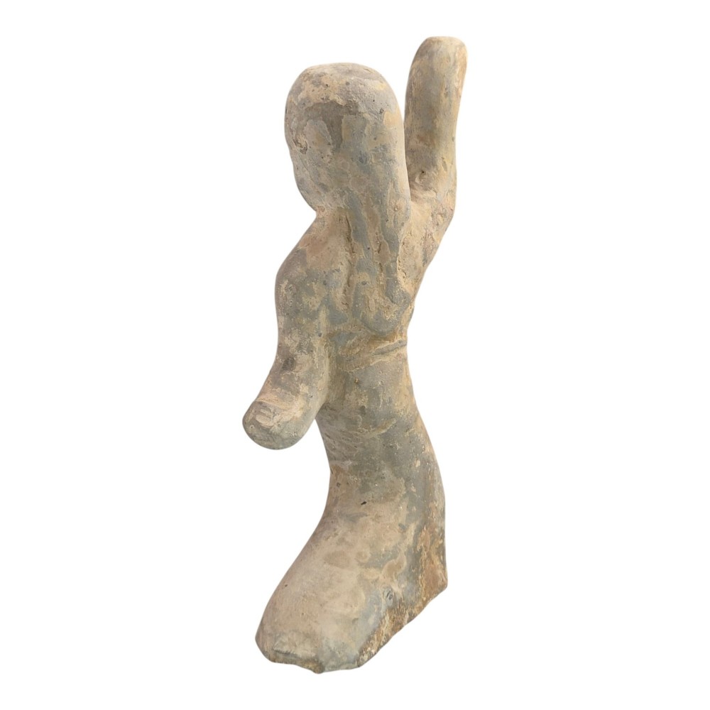 An ancient grey earthenware figure of a dancer in an S-shaped posture with one arm raised and an unglazed finish. View III