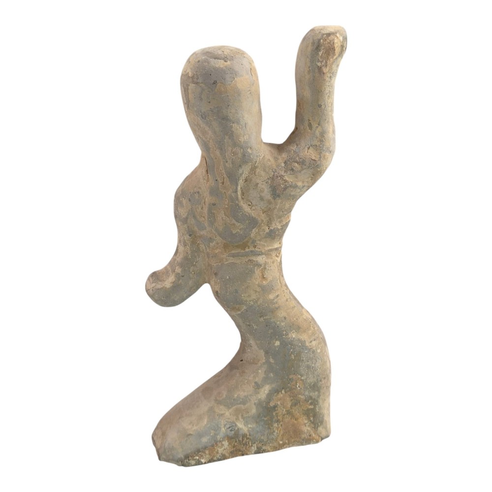 An ancient grey earthenware figure of a dancer in an S-shaped posture with one arm raised and an unglazed finish. View IV