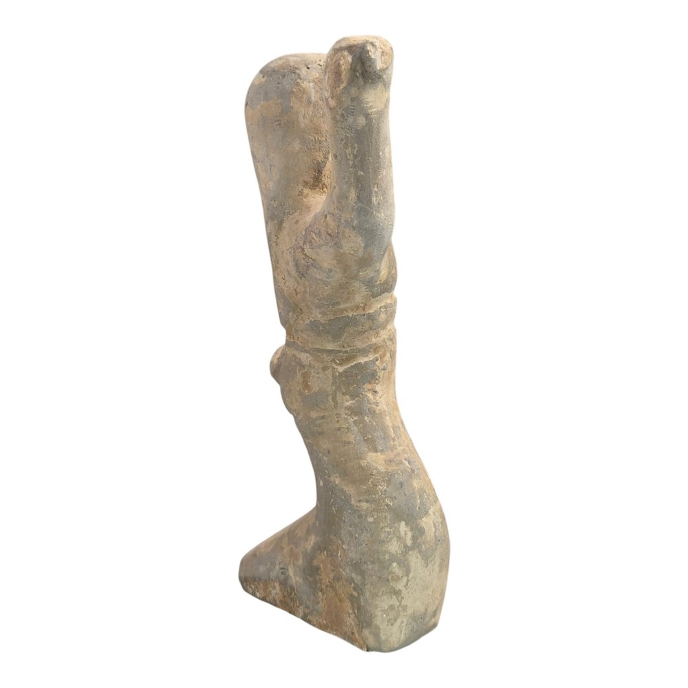 An ancient grey earthenware figure of a dancer in an S-shaped posture with one arm raised and an unglazed finish. View V