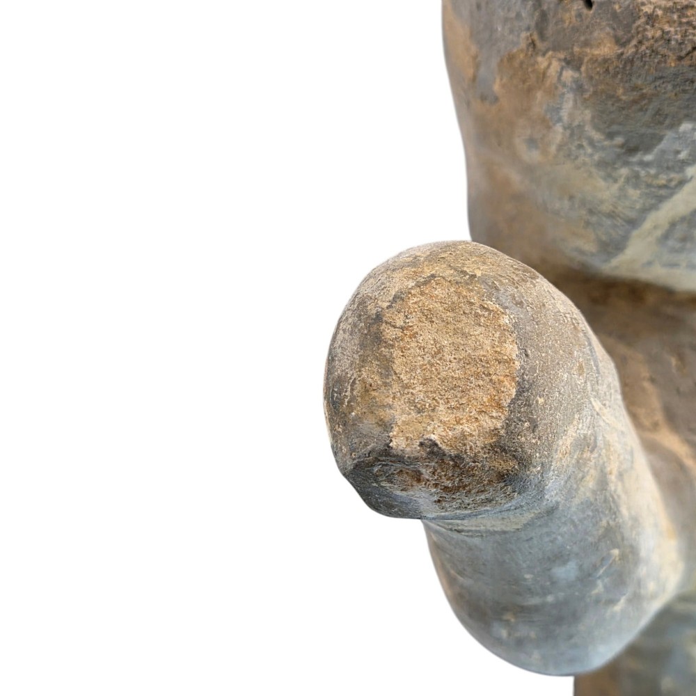 An ancient grey earthenware figure of a dancer in an S-shaped posture with one arm raised and an unglazed finish. View IX