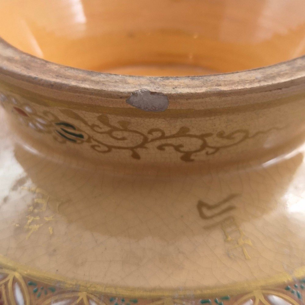 A bulbous Japanese Satsuma earthenware vase featuring a cream crackle glaze, intricate floral gilding, birds, and a carved dark wooden display stand. View V