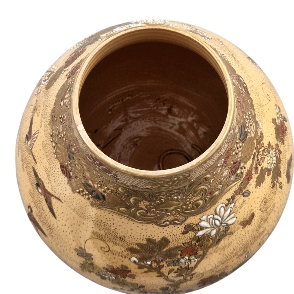 A bulbous Japanese Satsuma earthenware vase featuring a cream crackle glaze, intricate floral gilding, birds, and a carved dark wooden display stand. View XI