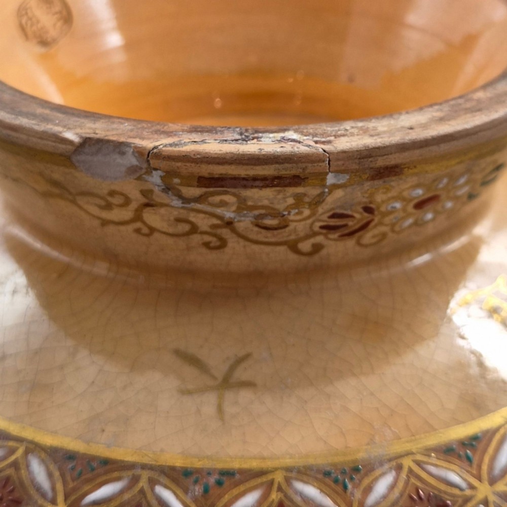 A bulbous Japanese Satsuma earthenware vase featuring a cream crackle glaze, intricate floral gilding, birds, and a carved dark wooden display stand. View XIV