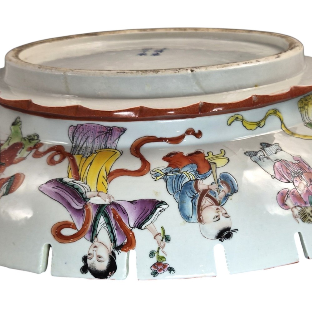 A late Qing dynasty Chinese Famille Rose porcelain dish featuring a hand-painted central figure, lotus blossoms, butterflies, and a distinct red castellated rim. View VIII
