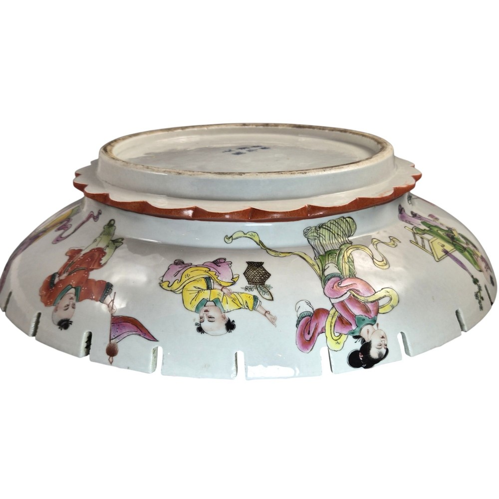 A late Qing dynasty Chinese Famille Rose porcelain dish featuring a hand-painted central figure, lotus blossoms, butterflies, and a distinct red castellated rim. View XII