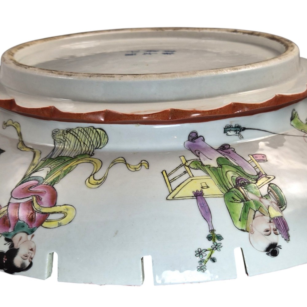 A late Qing dynasty Chinese Famille Rose porcelain dish featuring a hand-painted central figure, lotus blossoms, butterflies, and a distinct red castellated rim. View XIII