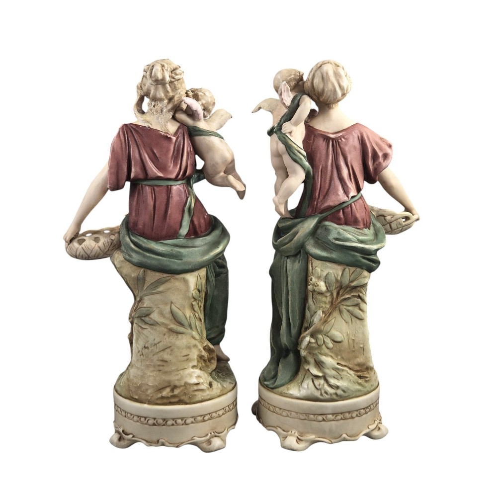 A pair of Royal Dux Art Nouveau porcelain figurines depicting classical maidens with winged cherubs and openwork baskets. View III