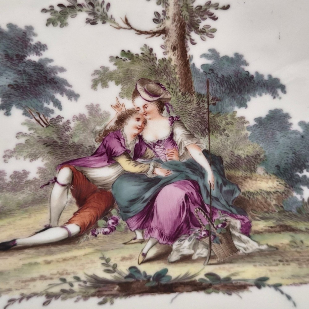 An oval 18th-century French porcelain tray featuring a hand-painted pastoral scene bordered by pink ribbon decoration and a scalloped gilt edge. View III
