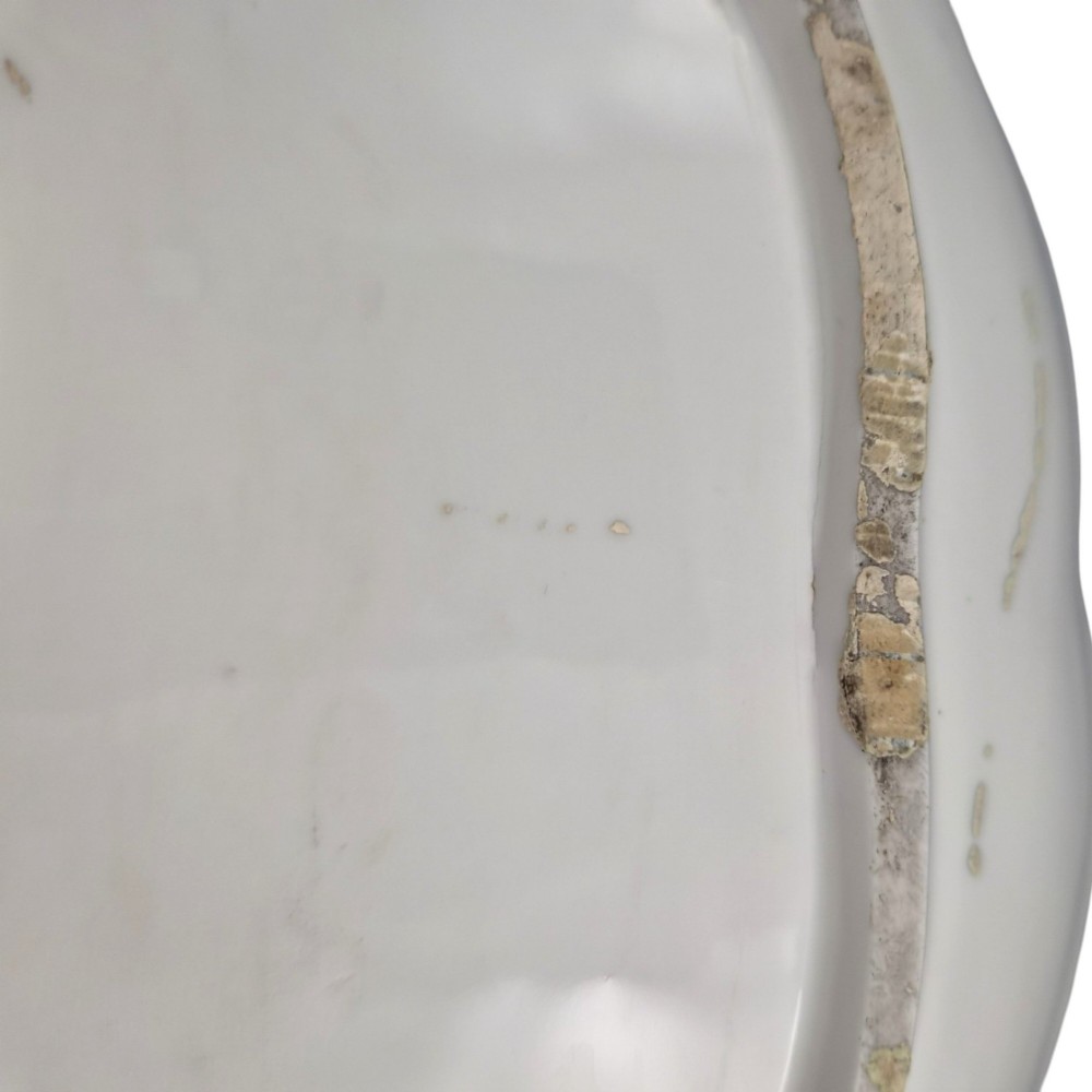 An oval 18th-century French porcelain tray featuring a hand-painted pastoral scene bordered by pink ribbon decoration and a scalloped gilt edge. View VII