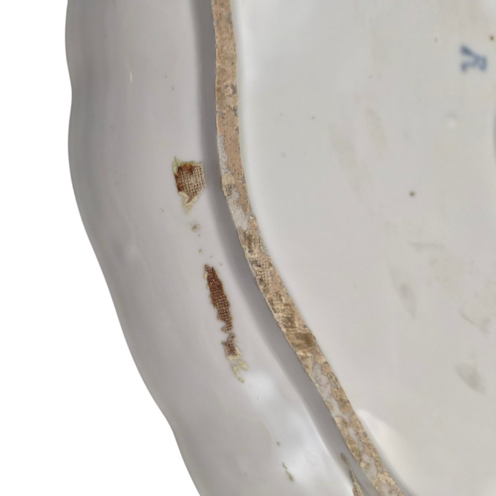An oval 18th-century French porcelain tray featuring a hand-painted pastoral scene bordered by pink ribbon decoration and a scalloped gilt edge. View VIII