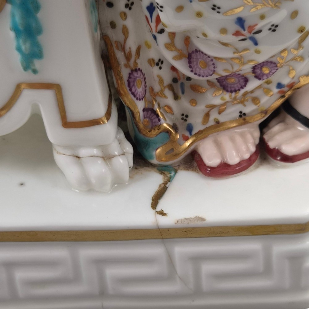 A Neoclassical porcelain figure depicting a draped female leaning against a gilded urn on a pedestal. View VII