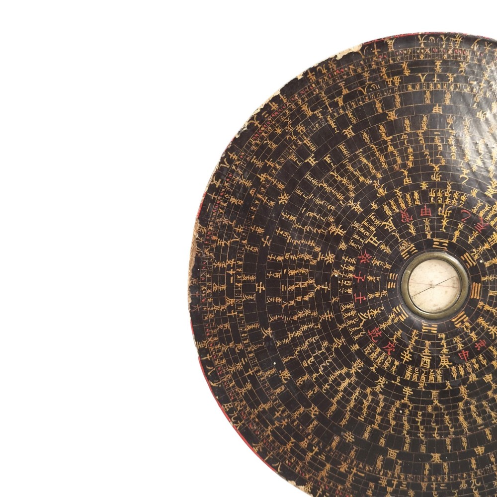 A circular antique Chinese Luopan geomantic compass crafted from dark lacquered wood featuring multiple concentric rings of gilded Chinese characters and a central brass magnetic dial. View IX