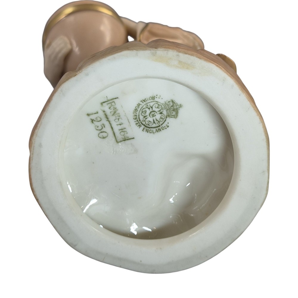 A pair of Royal Worcester blush ivory porcelain figures depicting a male and female Cairo water carrier with gilded accents. View VII