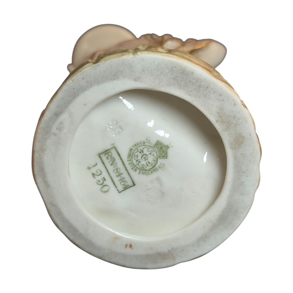 A pair of Royal Worcester blush ivory porcelain figures depicting a male and female Cairo water carrier with gilded accents. View XI