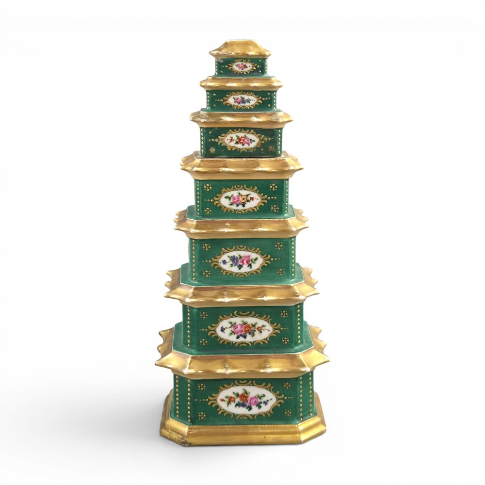 A multi-tiered green and gold porcelain pagoda-shaped perfume bottle featuring hand-painted floral cartouches on each section.