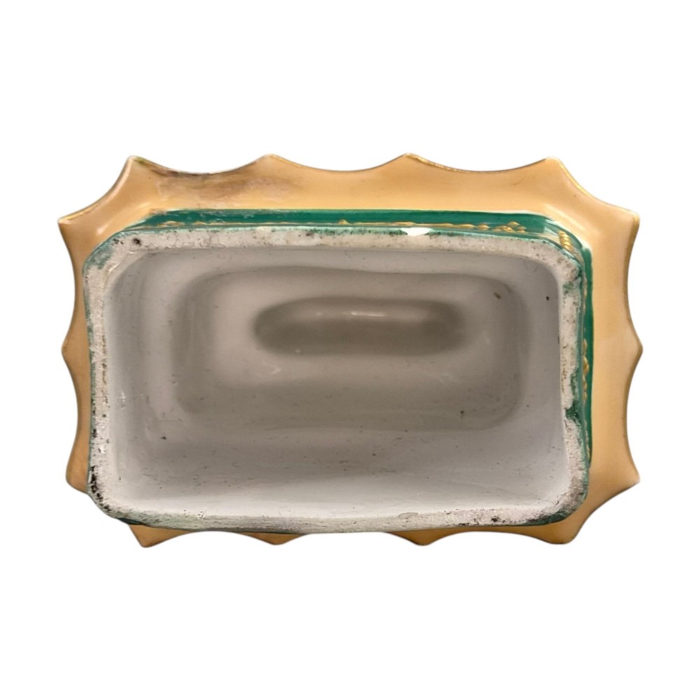 A multi-tiered green and gold porcelain pagoda-shaped perfume bottle featuring hand-painted floral cartouches on each section. View X