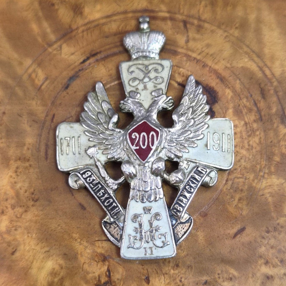 A rectangular Karelian birch box featuring a prominent silver and enamel Imperial Russian regimental badge mounted centrally on the lid. View IV