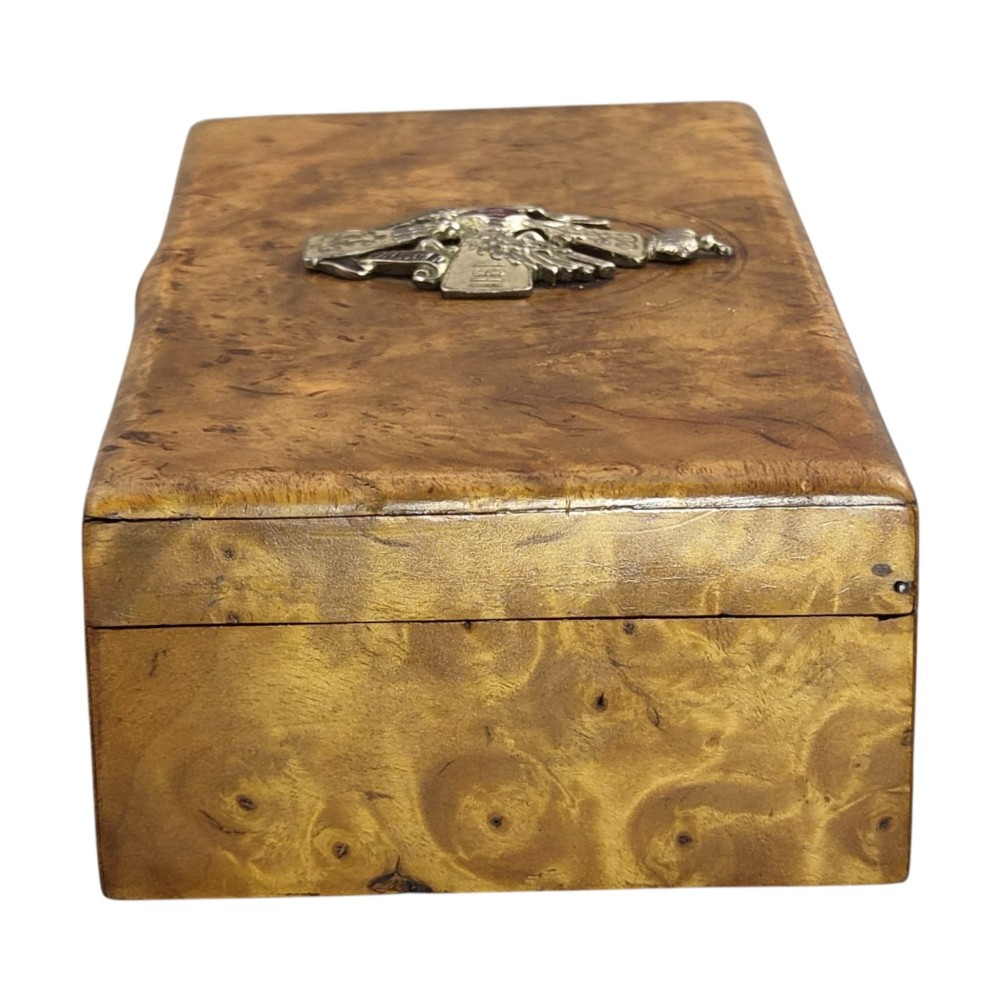 A rectangular Karelian birch box featuring a prominent silver and enamel Imperial Russian regimental badge mounted centrally on the lid. View VI