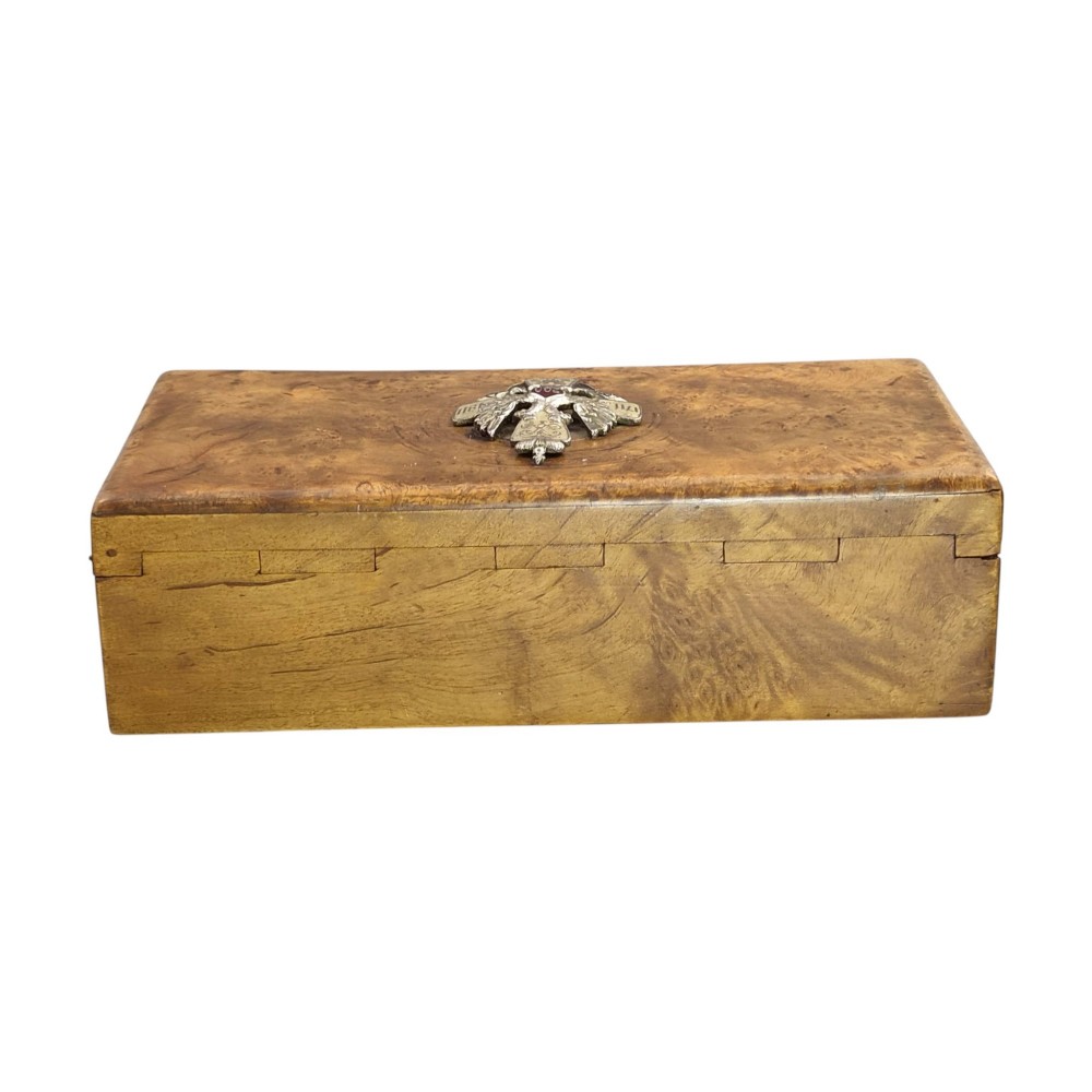 A rectangular Karelian birch box featuring a prominent silver and enamel Imperial Russian regimental badge mounted centrally on the lid. View VII