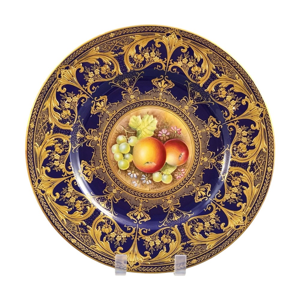 A circular Royal Worcester porcelain cabinet plate featuring a hand-painted fruit still life surrounded by a deep cobalt blue border decorated with intricate gold gilding. View II