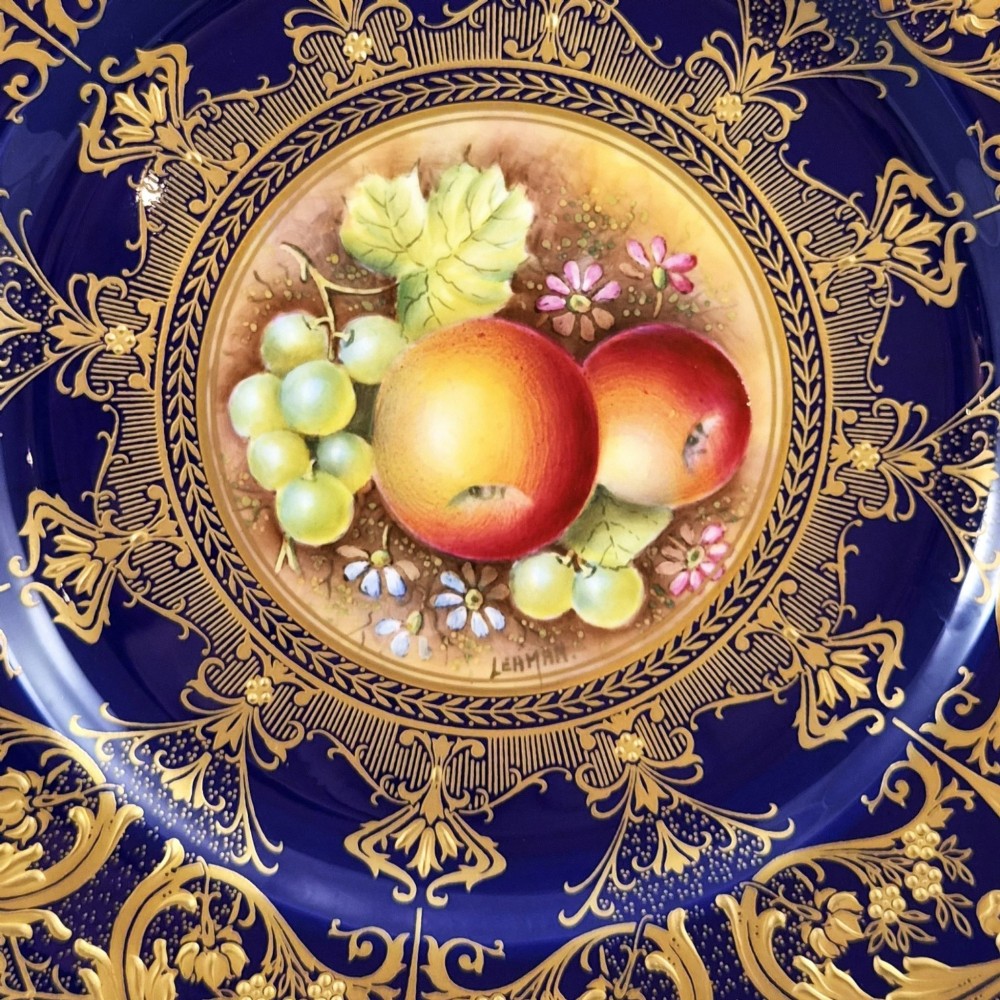 A circular Royal Worcester porcelain cabinet plate featuring a hand-painted fruit still life surrounded by a deep cobalt blue border decorated with intricate gold gilding. View III