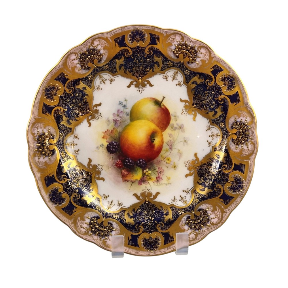 A circular Royal Worcester porcelain cabinet plate featuring hand-painted apples and berries in the centre surrounded by a cobalt blue border with heavy gold gilding. View II