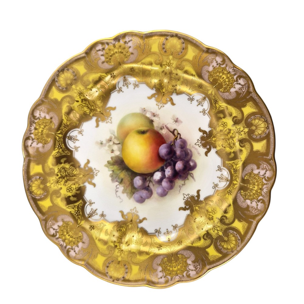 A circular Royal Worcester ceramic cabinet plate featuring a central hand-painted motif of apples and grapes surrounded by a gold gilt and yellow scrollwork border. View II