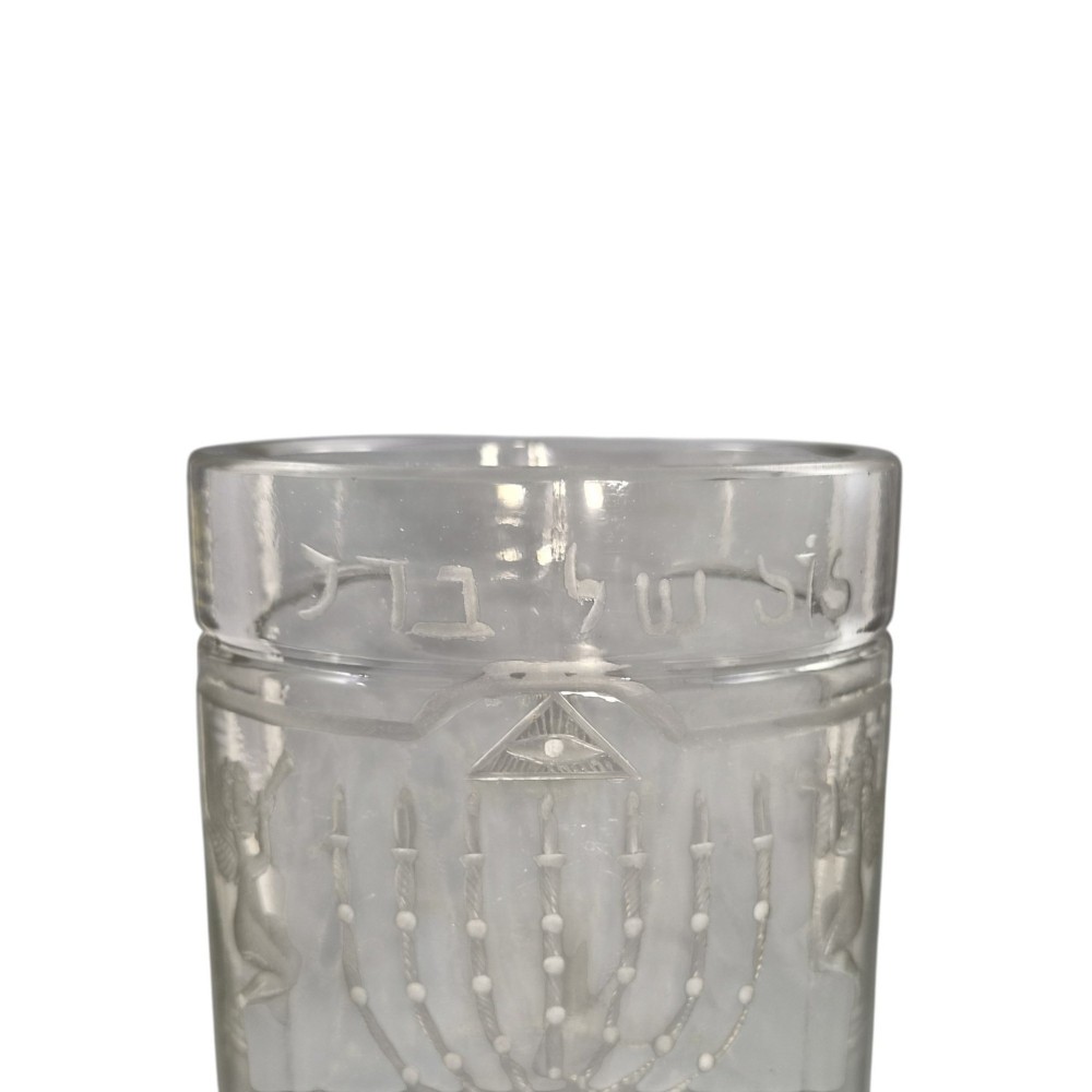 A large clear glass beaker featuring detailed wheel-engraved ceremonial iconography, vertical fluted panels near the lower rim, and a faceted base. View IV
