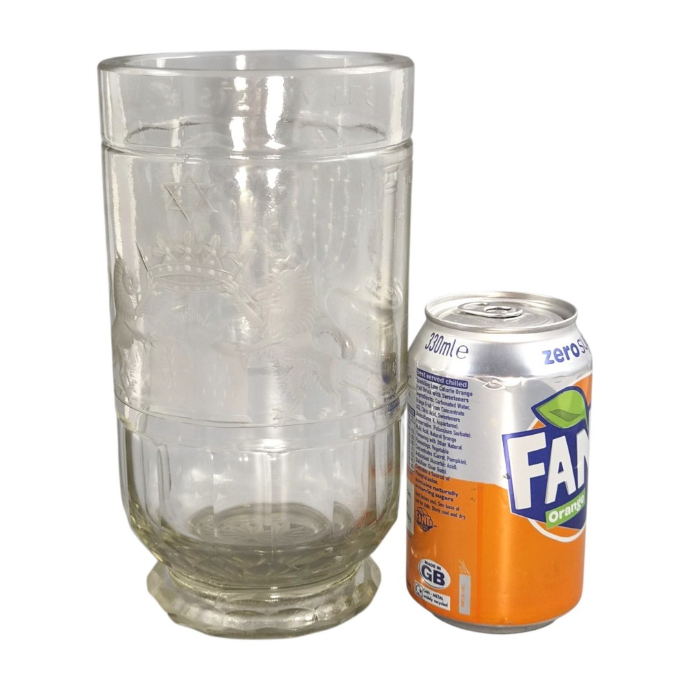 A large clear glass beaker featuring detailed wheel-engraved ceremonial iconography, vertical fluted panels near the lower rim, and a faceted base. View XIII