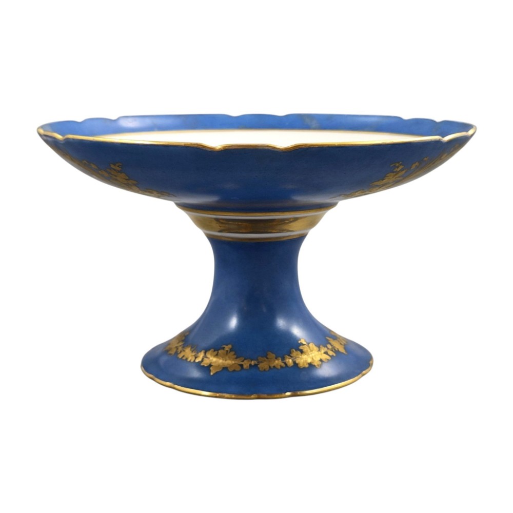 A cobalt blue and gilt porcelain tazza elevated on a pedestal base, adorned with a hand-painted winter landscape cartouche. View II