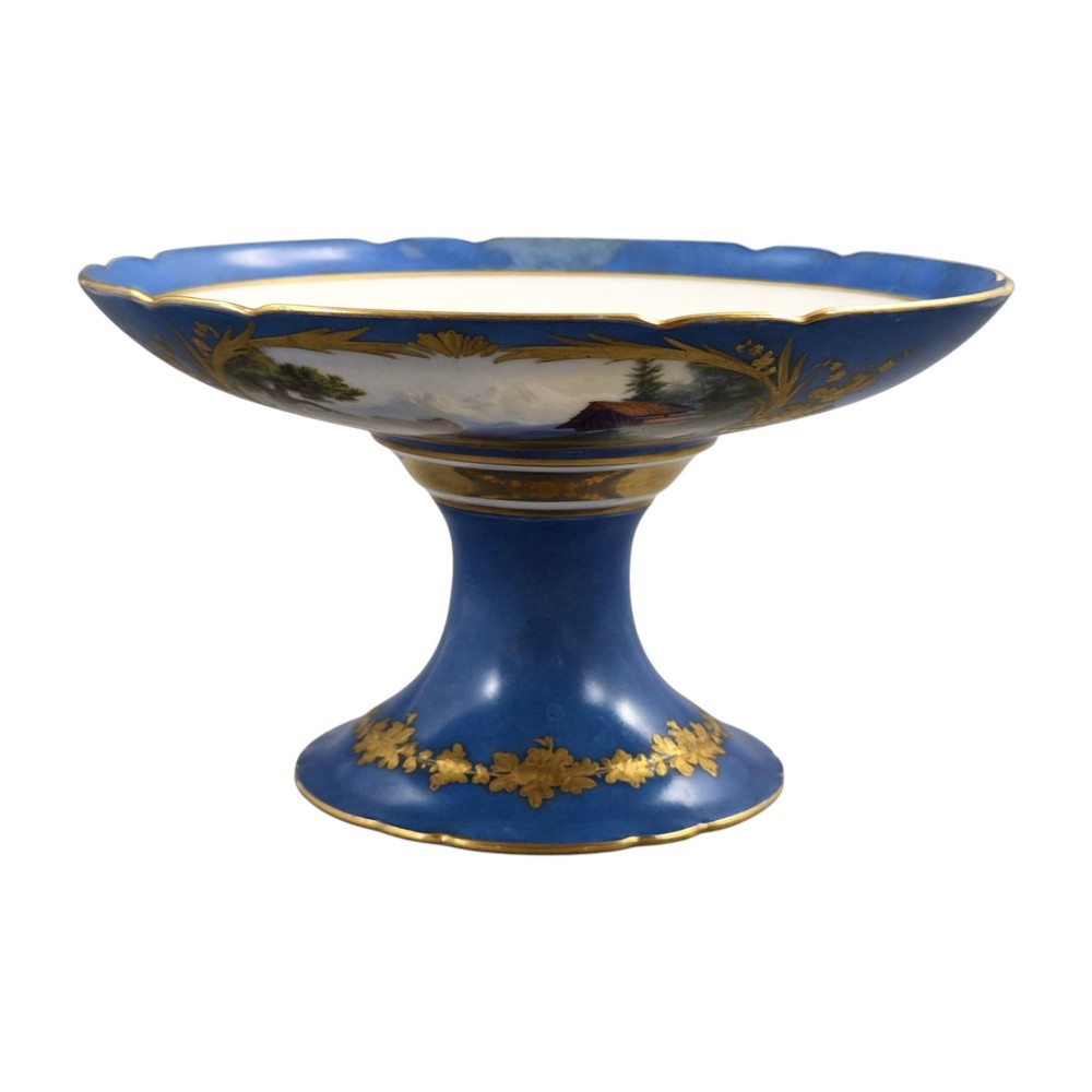 A cobalt blue and gilt porcelain tazza elevated on a pedestal base, adorned with a hand-painted winter landscape cartouche. View III