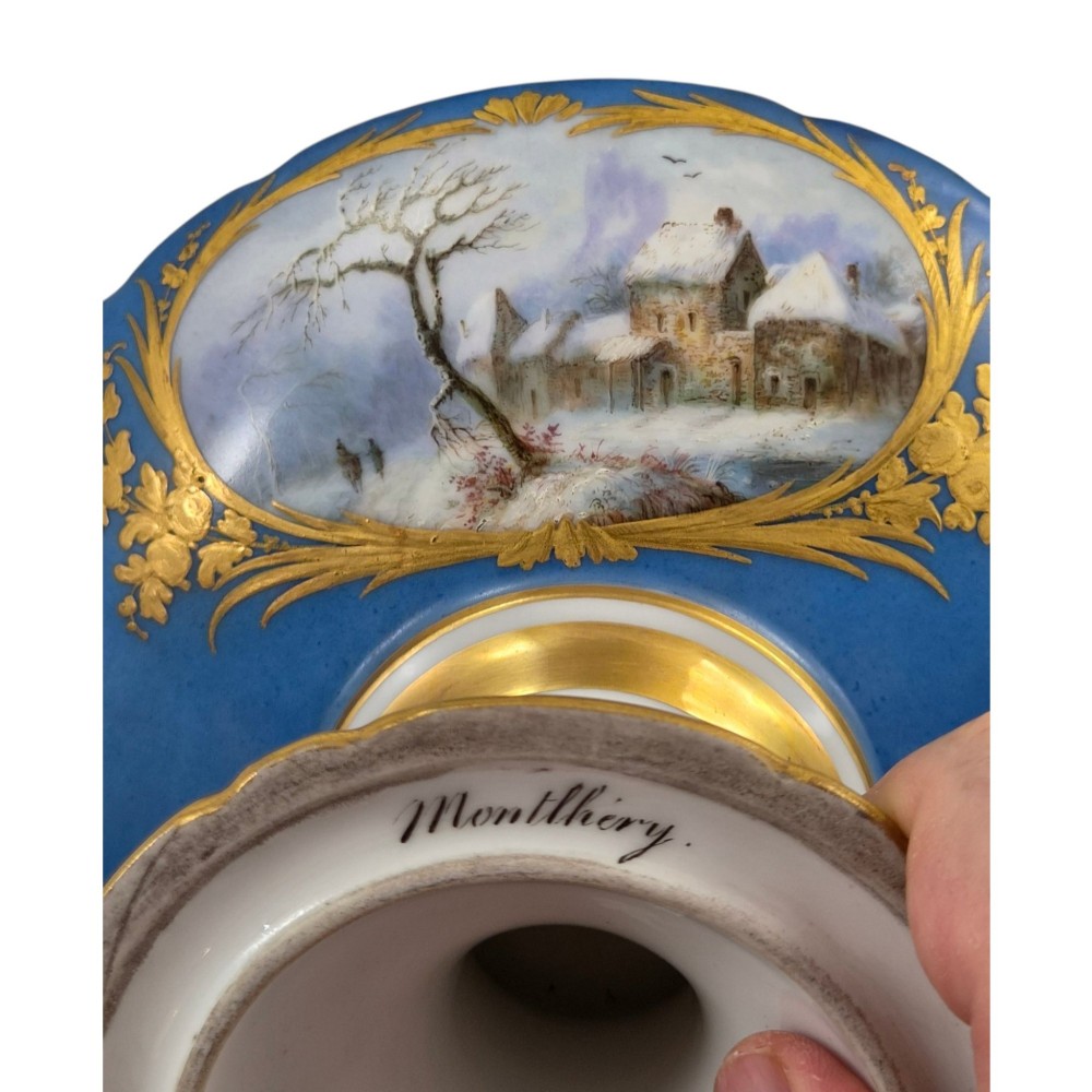 A cobalt blue and gilt porcelain tazza elevated on a pedestal base, adorned with a hand-painted winter landscape cartouche. View VII
