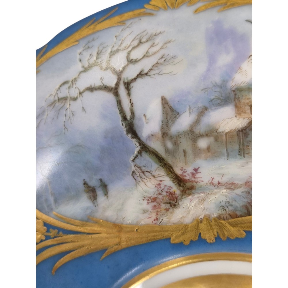 A cobalt blue and gilt porcelain tazza elevated on a pedestal base, adorned with a hand-painted winter landscape cartouche. View X
