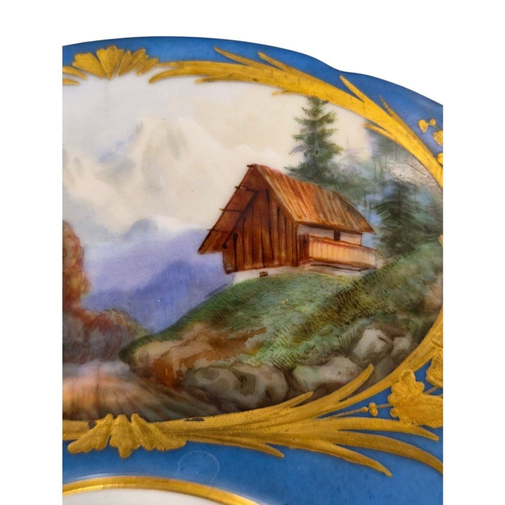A cobalt blue and gilt porcelain tazza elevated on a pedestal base, adorned with a hand-painted winter landscape cartouche. View XI