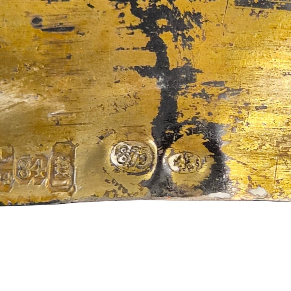 A rectangular antique Orthodox silver icon featuring repousse depictions of the Three Holy Hierarchs with detailed halos and Cyrillic script along the bottom edge. View II