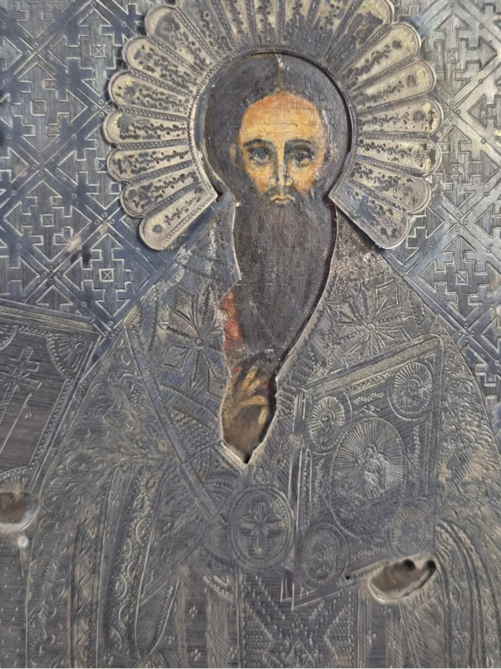 A rectangular antique Orthodox silver icon featuring repousse depictions of the Three Holy Hierarchs with detailed halos and Cyrillic script along the bottom edge. View VII