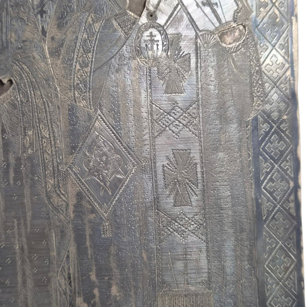 A rectangular antique Orthodox silver icon featuring repousse depictions of the Three Holy Hierarchs with detailed halos and Cyrillic script along the bottom edge. View IX