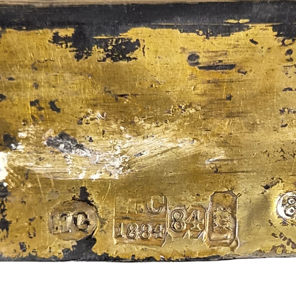 A rectangular antique Orthodox silver icon featuring repousse depictions of the Three Holy Hierarchs with detailed halos and Cyrillic script along the bottom edge. View XV