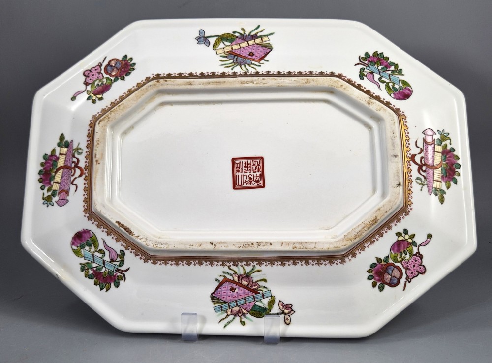 An octagonal Chinese Famille Rose porcelain tray depicting figures in a garden court scene surrounded by floral and butterfly borders. View II