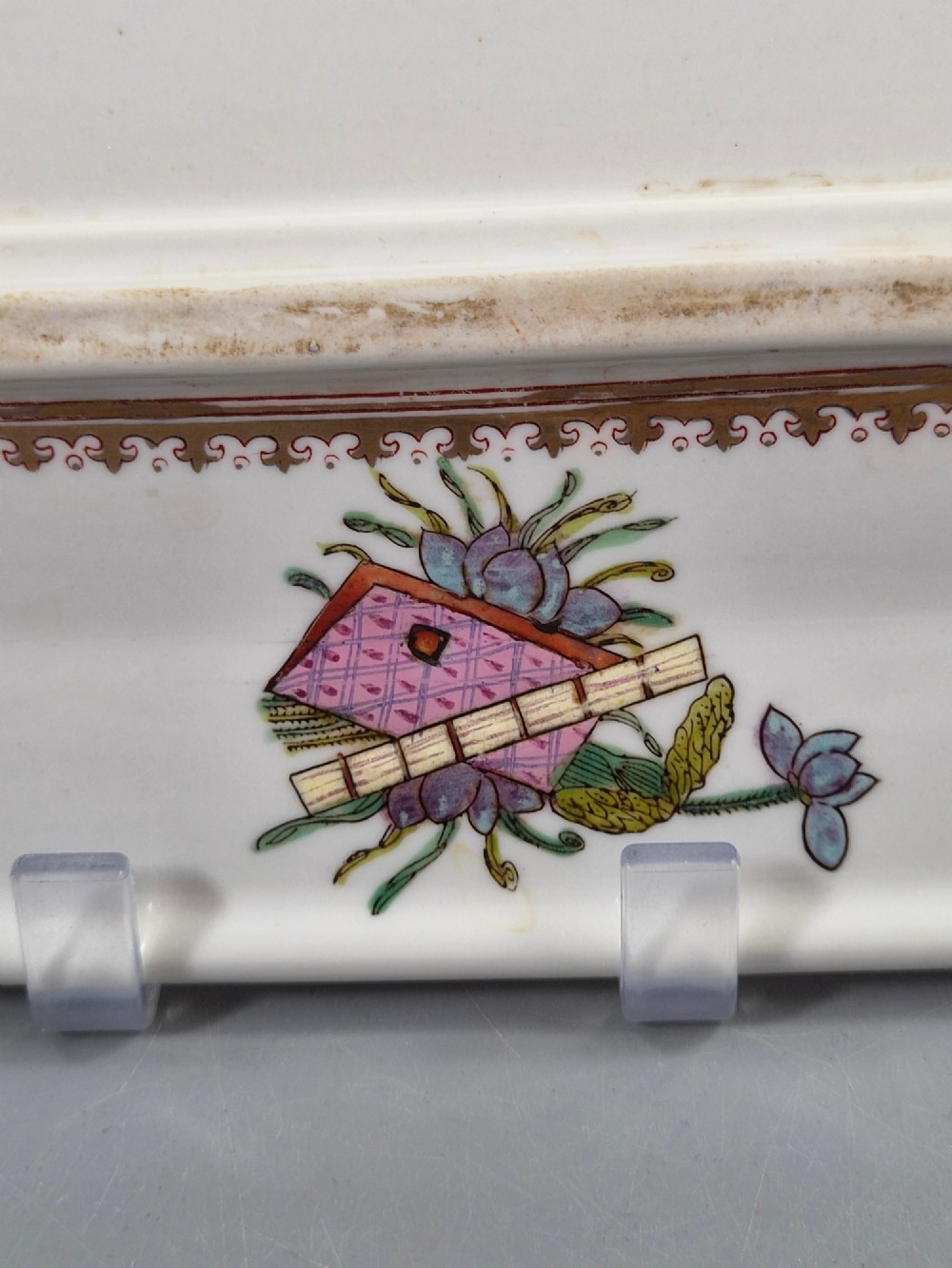 An octagonal Chinese Famille Rose porcelain tray depicting figures in a garden court scene surrounded by floral and butterfly borders. View VI