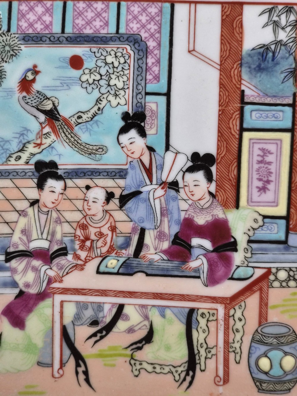 An octagonal Chinese Famille Rose porcelain tray depicting figures in a garden court scene surrounded by floral and butterfly borders. View VIII