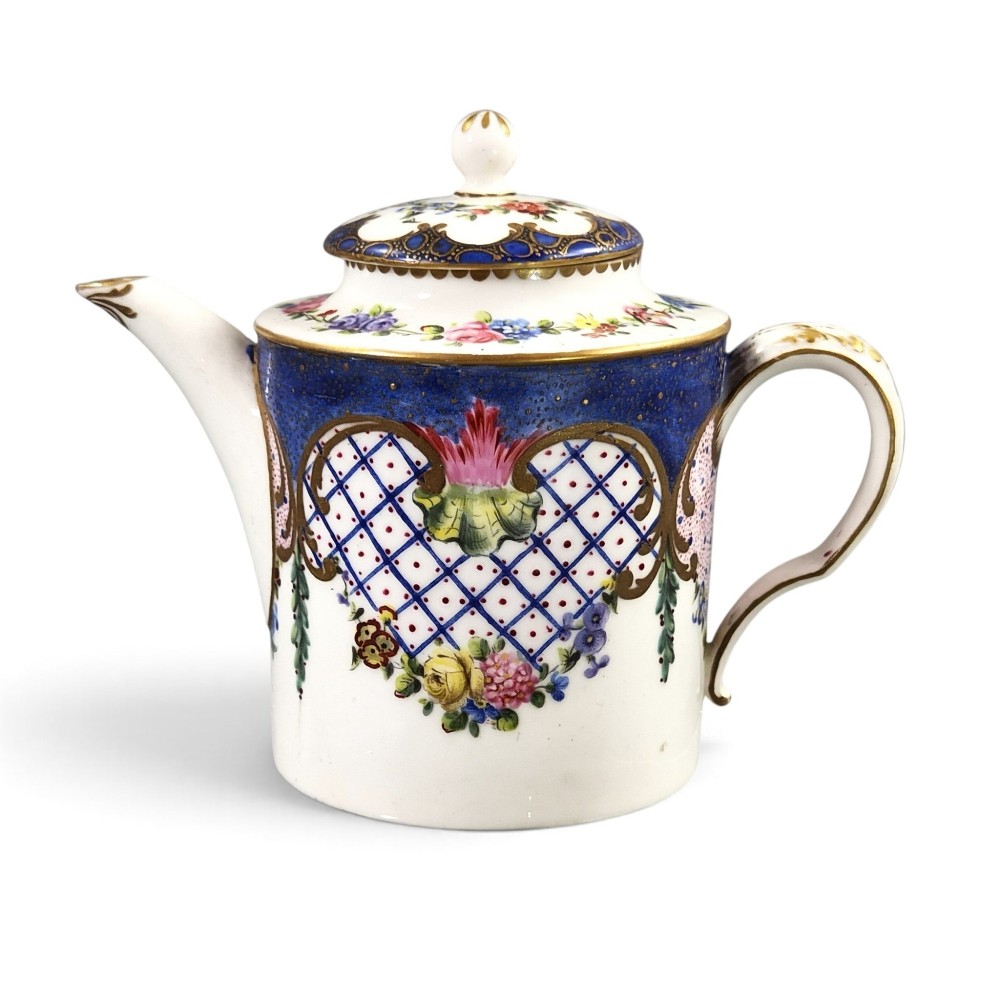 An 18th-century French Sevres soft-paste porcelain litron teapot decorated with hand-painted floral cartouches, gilding, and cobalt blue borders.
