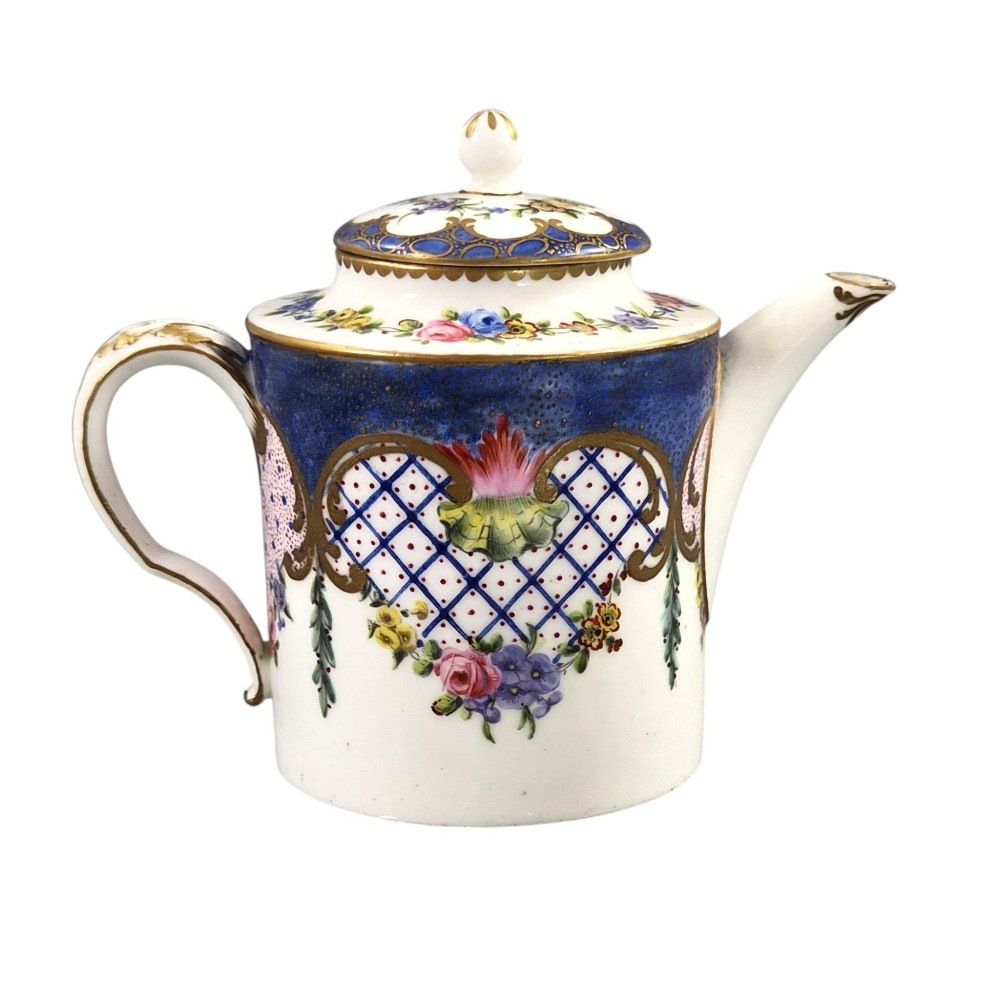 An 18th-century French Sevres soft-paste porcelain litron teapot decorated with hand-painted floral cartouches, gilding, and cobalt blue borders. View III