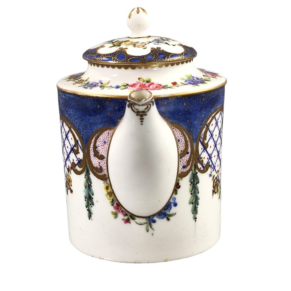 An 18th-century French Sevres soft-paste porcelain litron teapot decorated with hand-painted floral cartouches, gilding, and cobalt blue borders. View IV