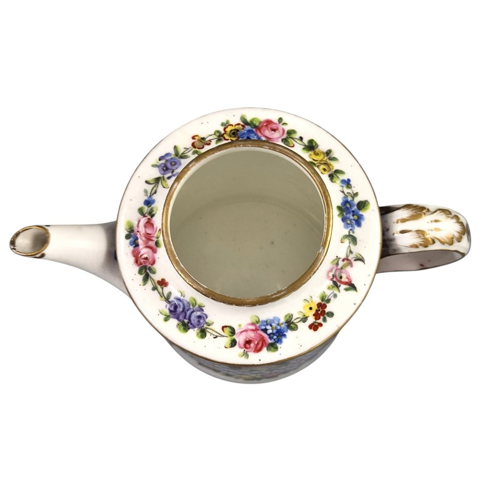 An 18th-century French Sevres soft-paste porcelain litron teapot decorated with hand-painted floral cartouches, gilding, and cobalt blue borders. View VI