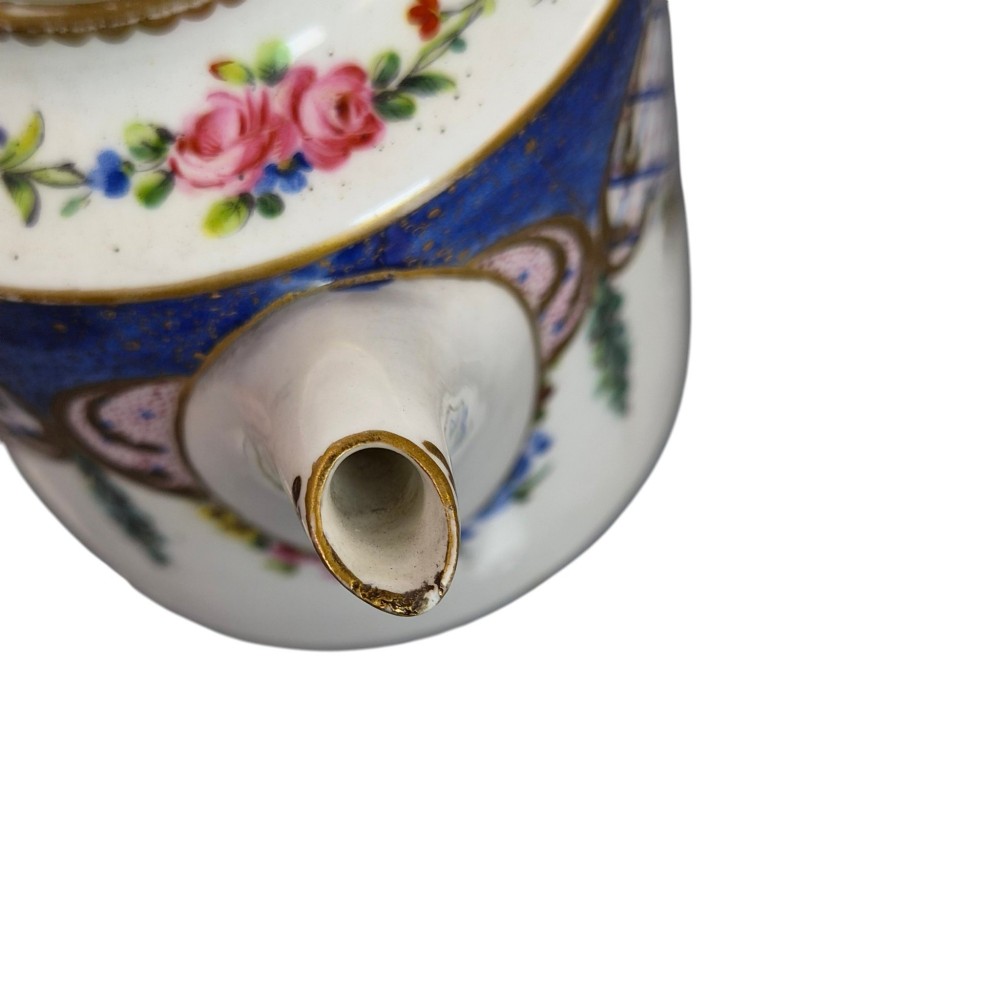 An 18th-century French Sevres soft-paste porcelain litron teapot decorated with hand-painted floral cartouches, gilding, and cobalt blue borders. View IX